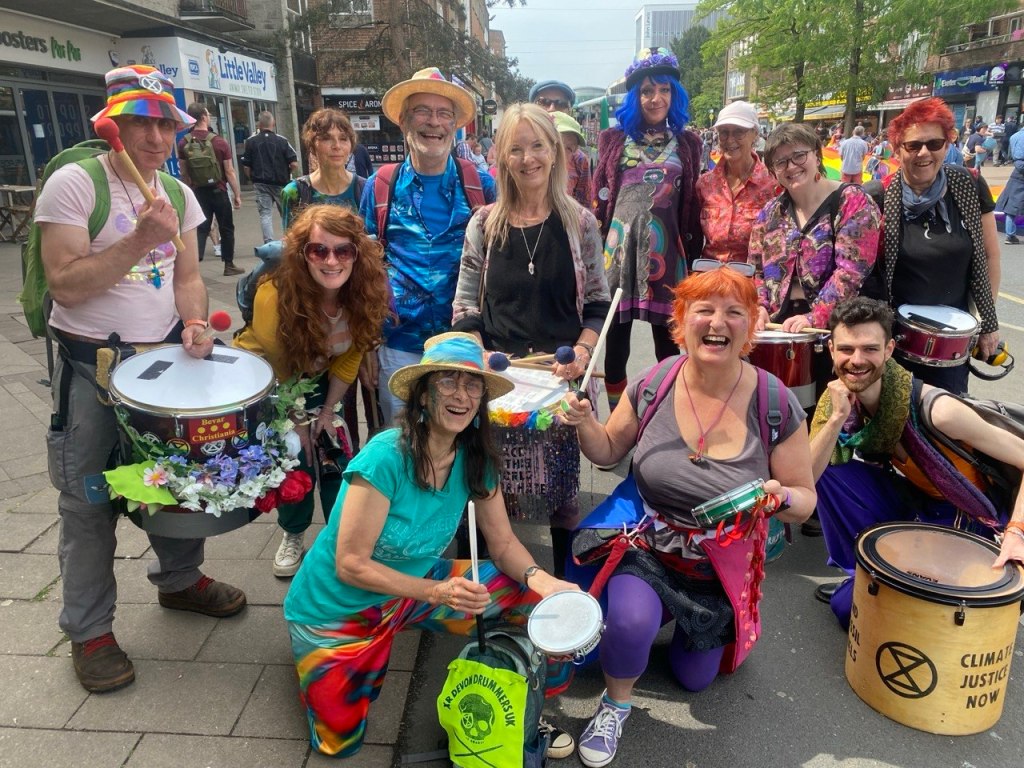 A group photo of the Devon Drummers posing at Exeter Pride.